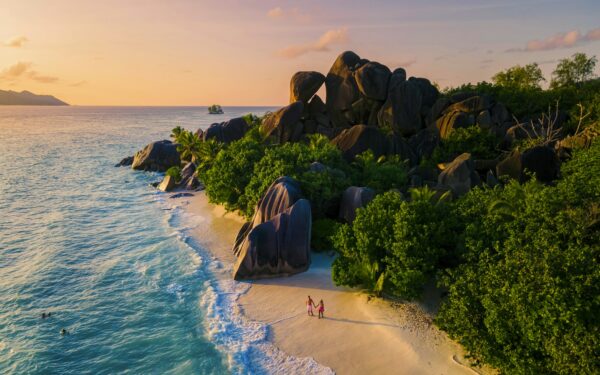 Anse Source d'Argent, La Digue Seychelles, young couple men and woman on a tropical beach