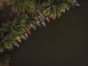 Top view shot of colorful small boats parked near the lakeside in Paradise Beach, Pondicherry