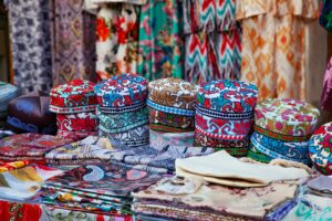 Traditional uzbek clothes such as skullcaps and other colorful souvenirs, Tashkent, Uzbekistan